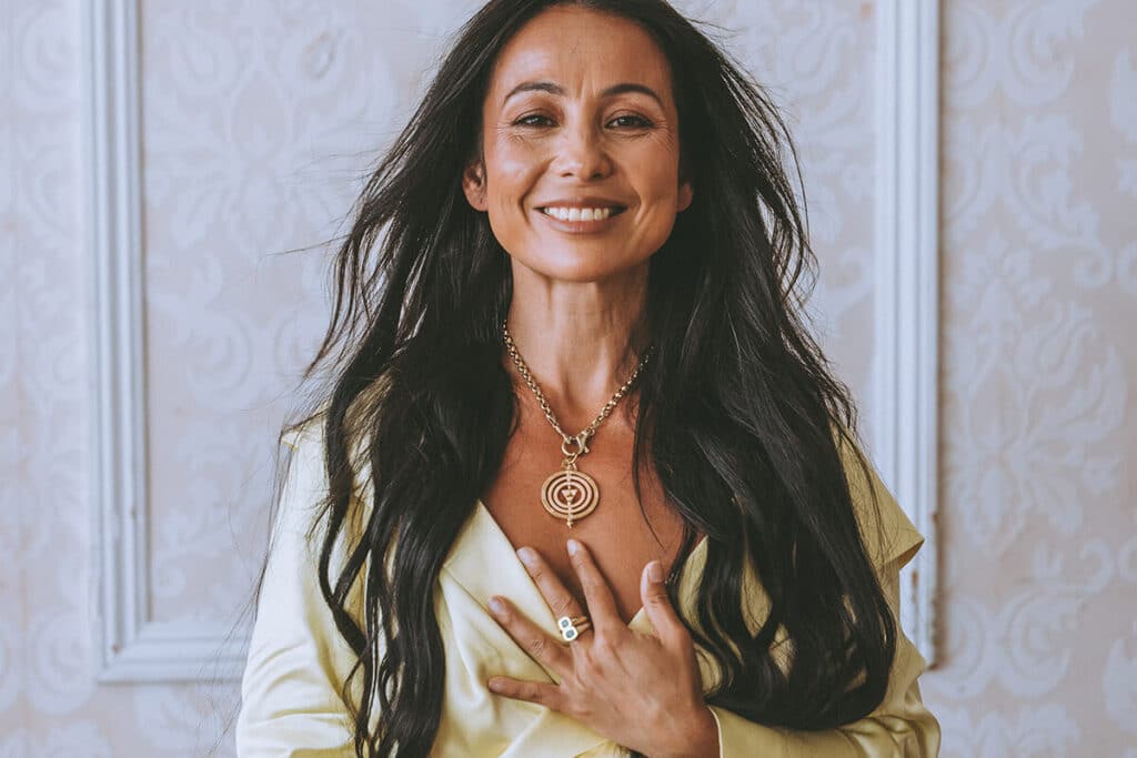 Close-up of hands wearing statement rings and bracelets on set during a personal brand shoot