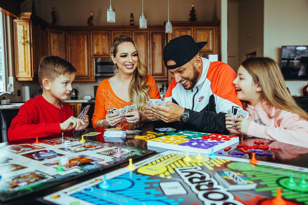 Jaramy Wilson laughing with family during board game night — joy, relatability, and human connection