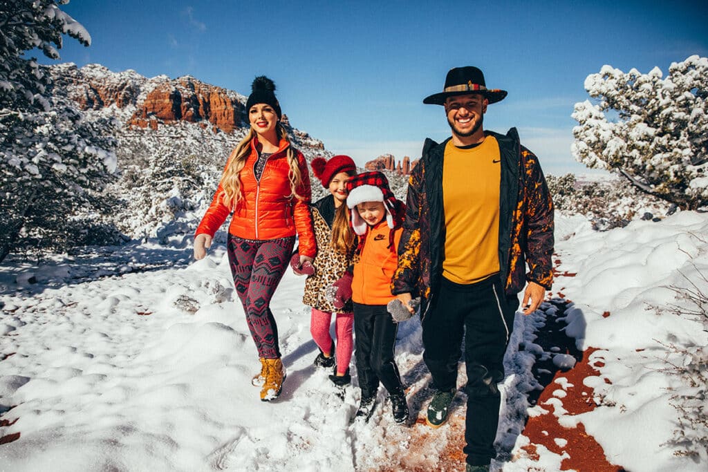 Jaramy Wilson and family hiking through snow, symbolizing leadership, adventure, and unity
