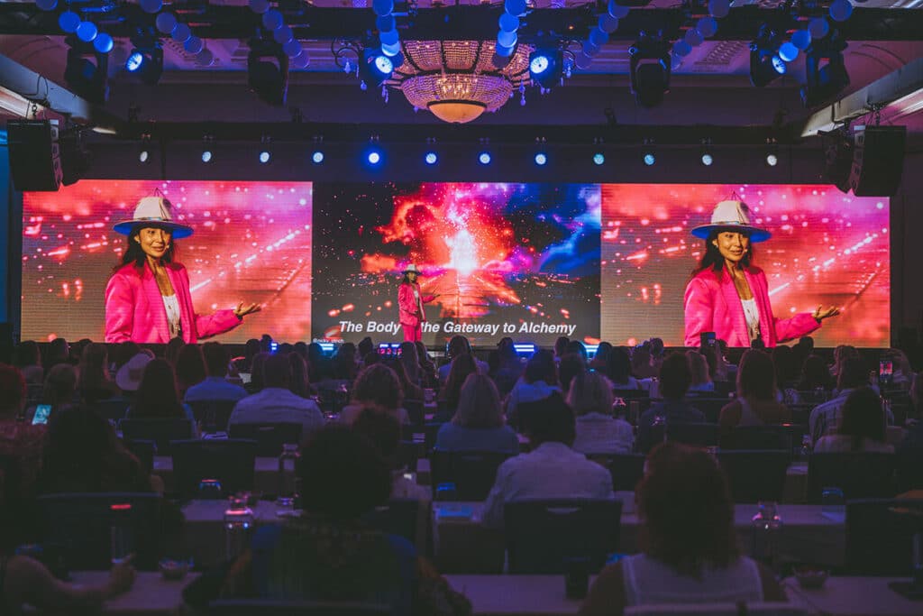 Thought leader presenting on stage to a captivated audience.
