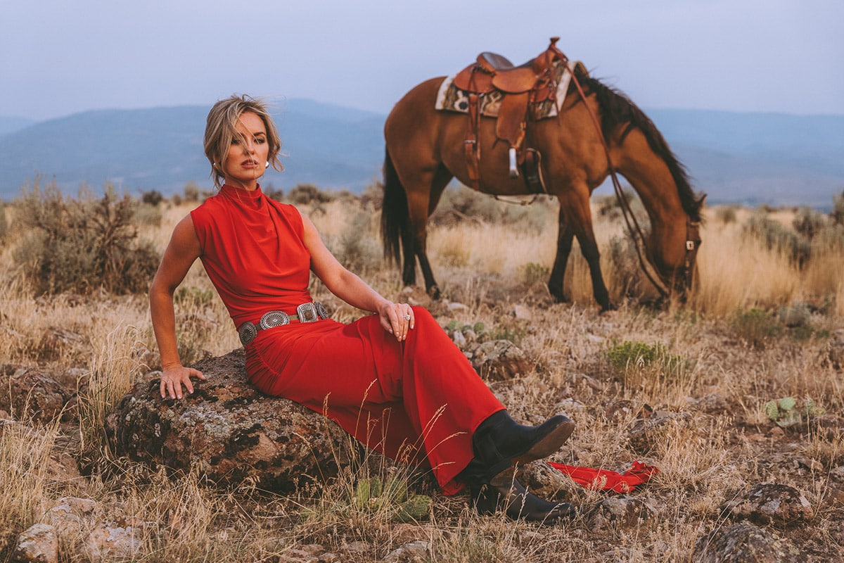 Entrepreneur in a bold, vibrant outfit standing confidently on location during a personal brand shoot