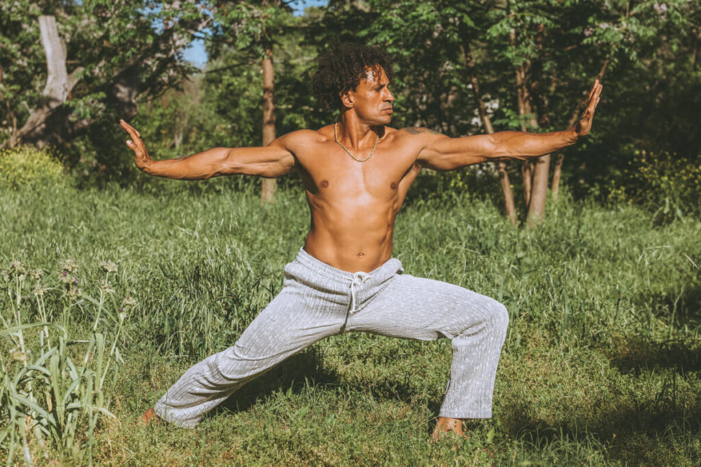 Branden Collinsworth holding a grounded, powerful pose in nature—showcasing strength, presence, and embodied confidence for a personal brand photoshoot