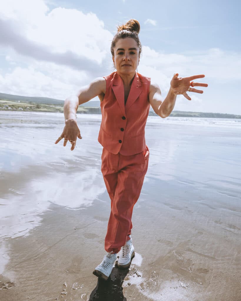 Emma Reicher captured in a candid, expressive moment mid-shoot, reflecting her transformation and aligned personal energy.