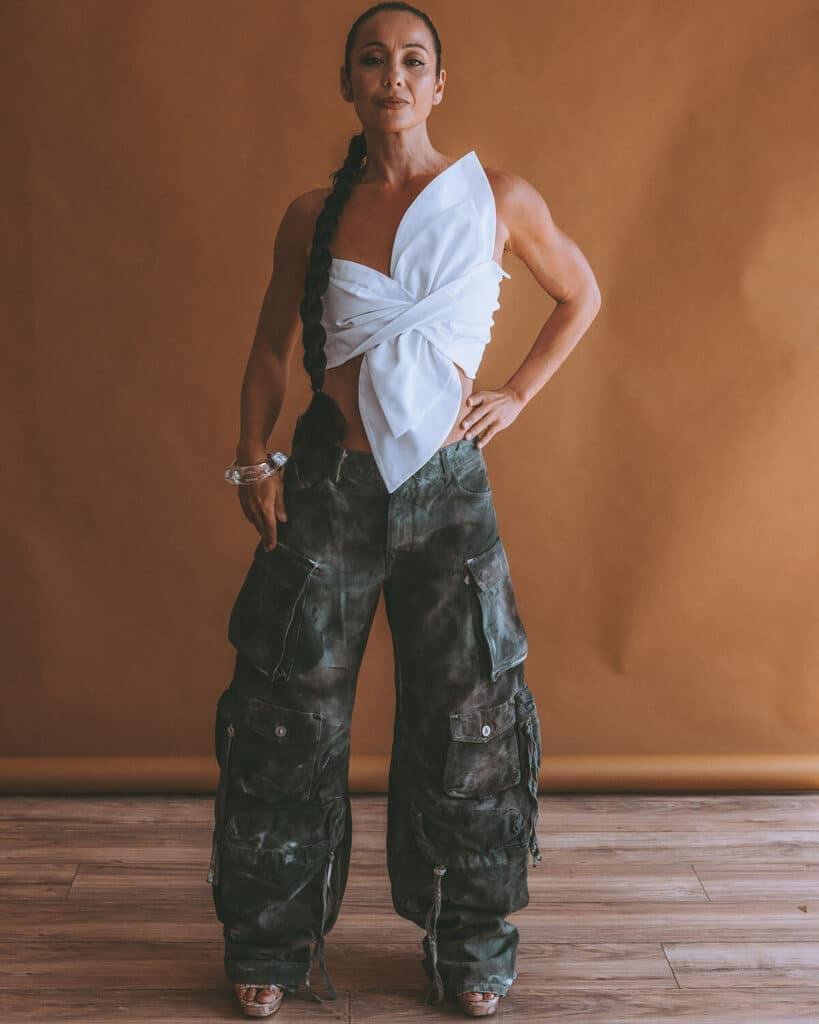 Nicky Clinch standing confidently in elevated, fashion-forward attire during a personal brand shoot—embodying power, authenticity, and strategic wardrobe styling for leadership positioning