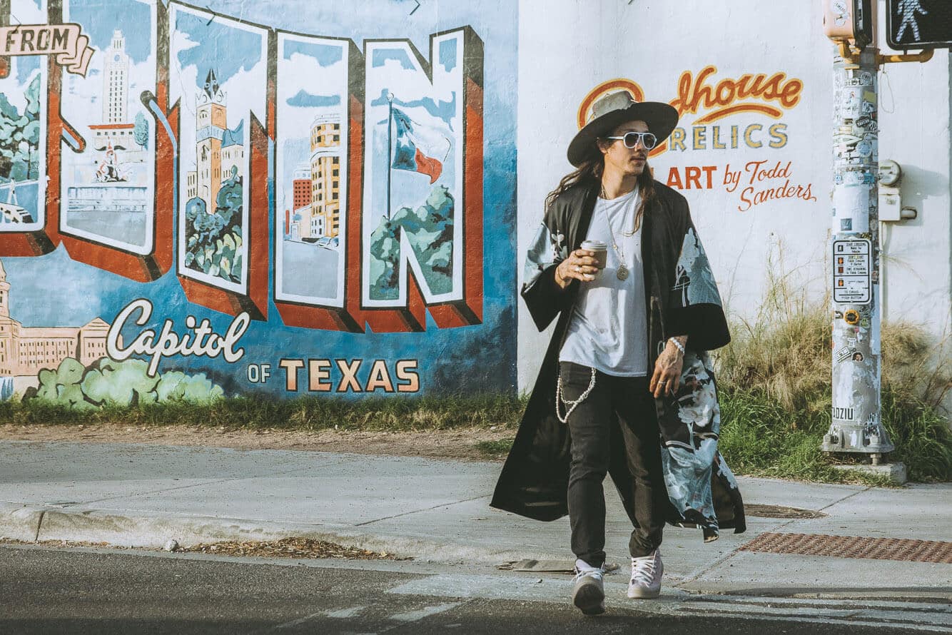 Nick Onken directing a subject during a stylish personal brand shoot in an iconic Austin setting
