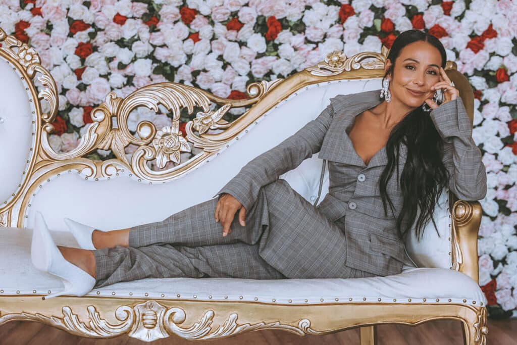Nicky Clinch seated indoors in a powerful silhouette, styled by Ivanna Fontana—radiating grounded leadership and modern authority