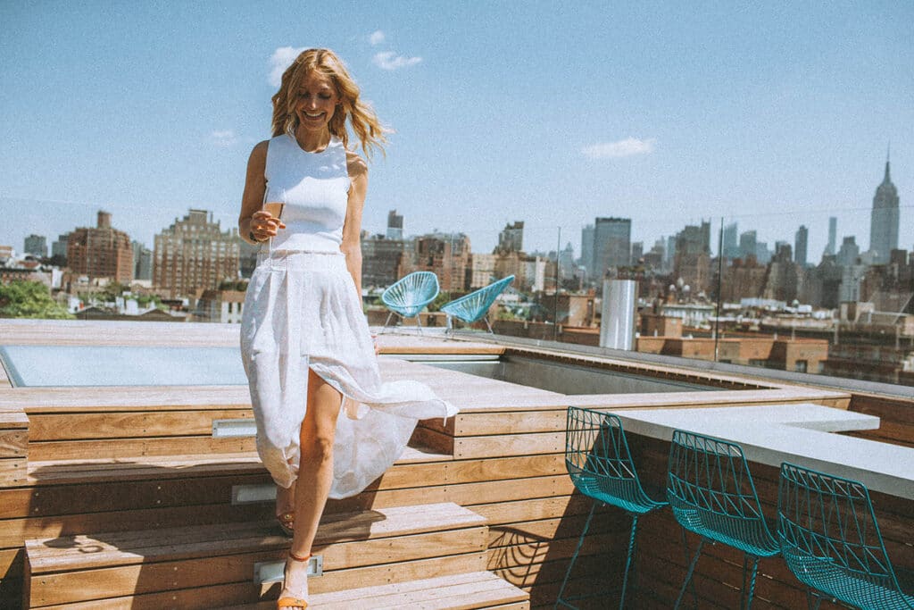 A personal brand client mid-movement, walking confidently while smiling, captured in natural light