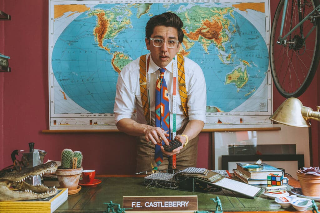 Creative entrepreneur in a bold, stylized office surrounded by eclectic props and a global map—showcasing a personal brand environment that reflects innovation, personality, and cinematic storytelling