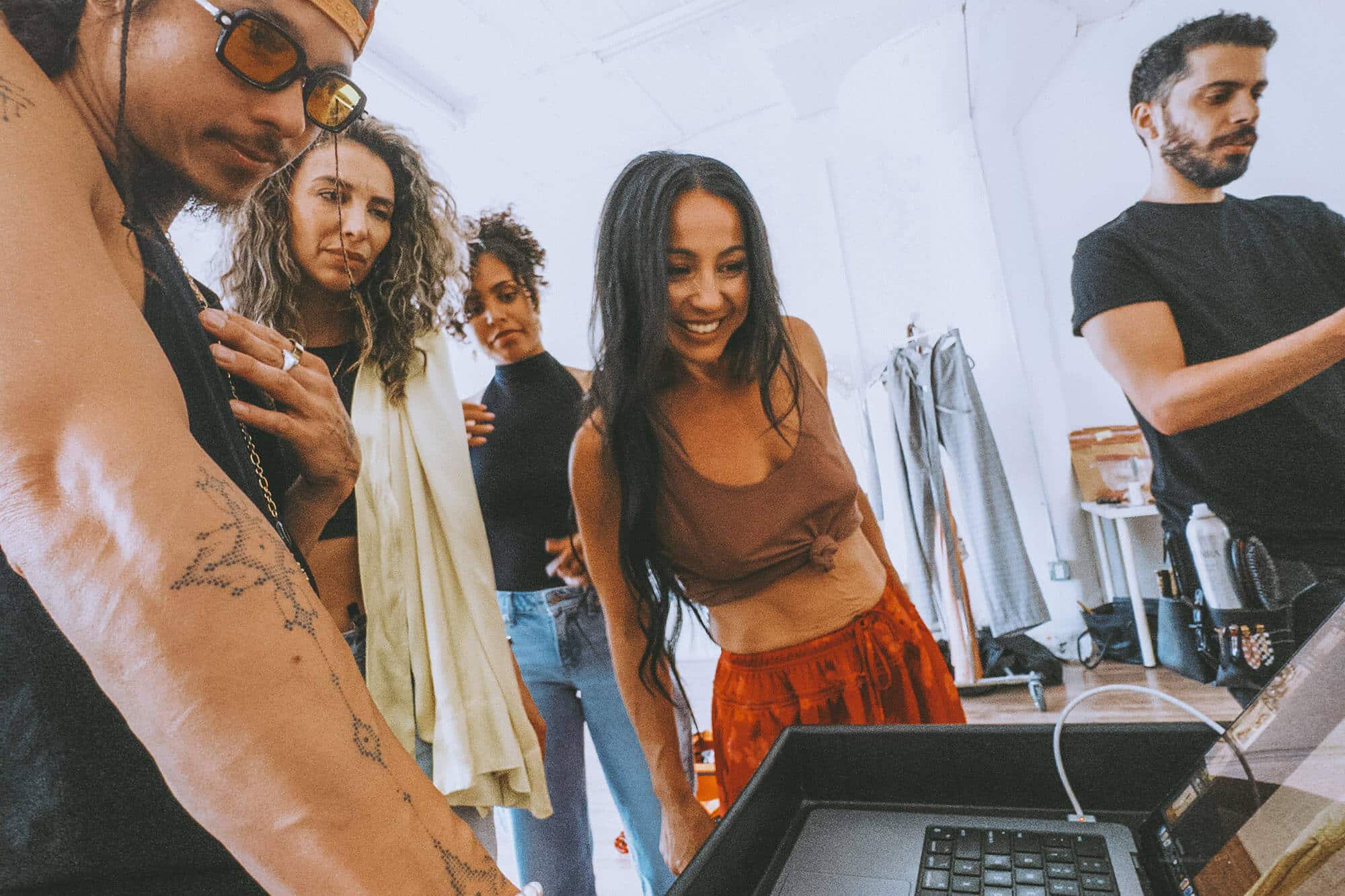 A creative team reviewing photo previews with a client during a personal brand shoot, showcasing collaborative planning and leadership-focused visual strategy