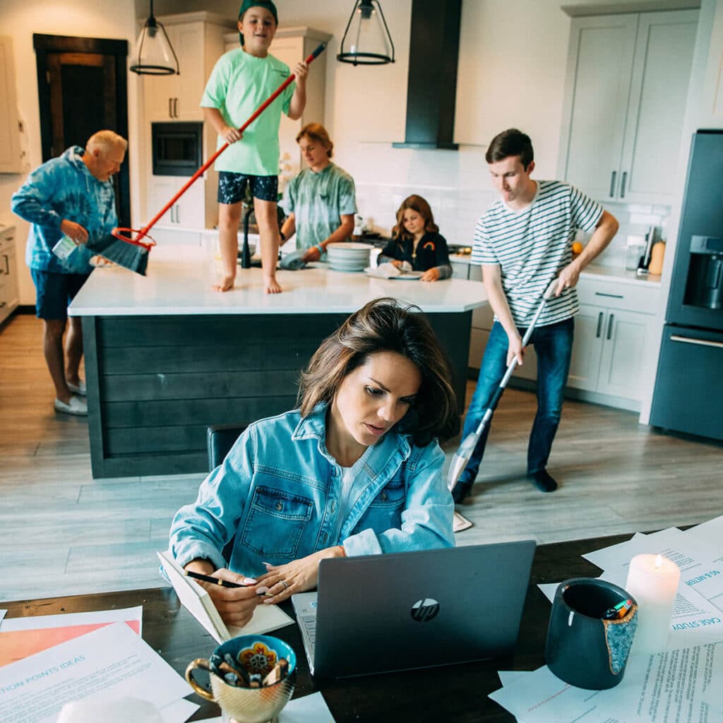 Creative entrepreneur in an elevated living space surrounded by curated design, showing how brand and lifestyle integrate
