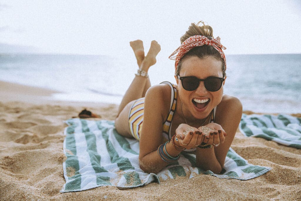 Personal brand photography client mid-laugh in a vibrant environment, radiating confidence and presence