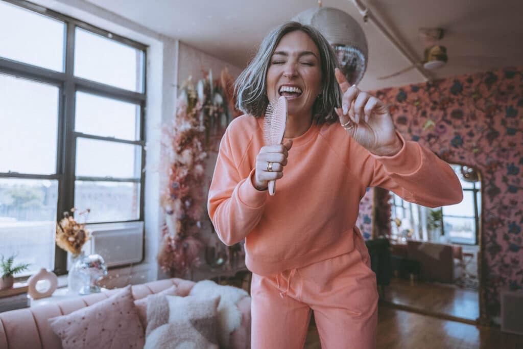 Entrepreneur mid-laugh in a stylized interior shoot, radiating confidence and identity through visual storytelling