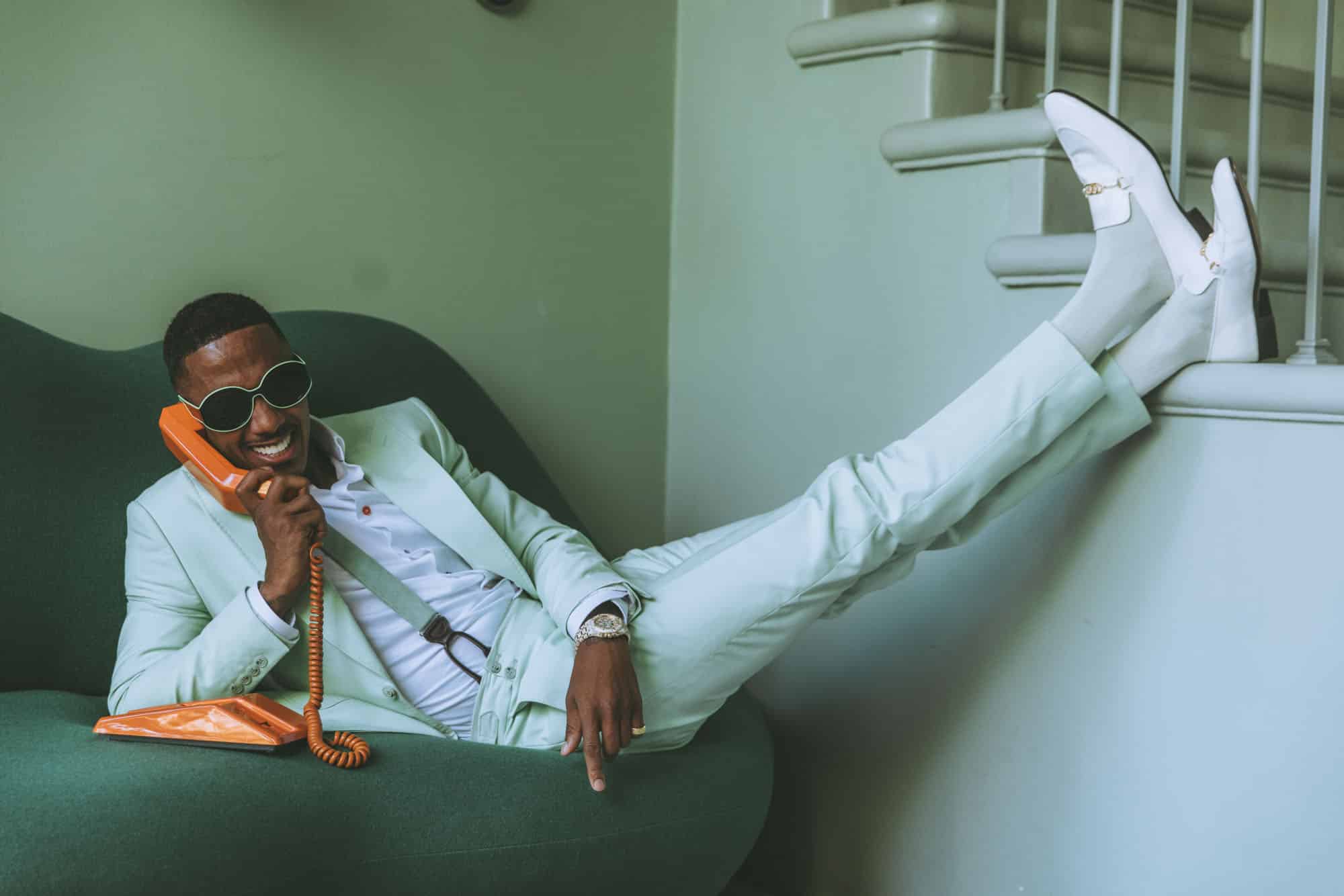 Entrepreneur being photographed in a modern studio space with professional lighting and styling by Nick Onken