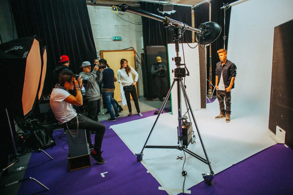 Behind the scenes of Nick Onken directing a personal brand photoshoot with professional lighting and creative direction