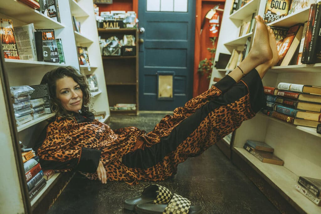 Evangeline Lilly in her favorite bookstore during authentic brand photography session
