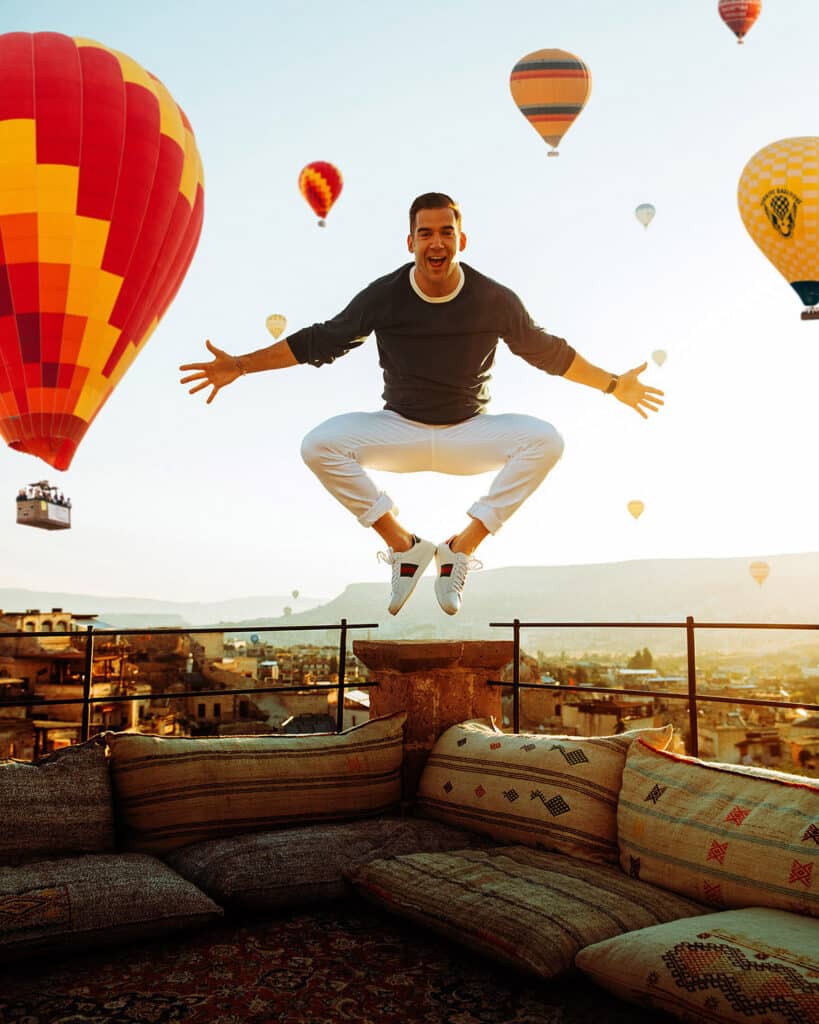 Lewis Howes standing in flowing robes with Cappadocia landscape in the background