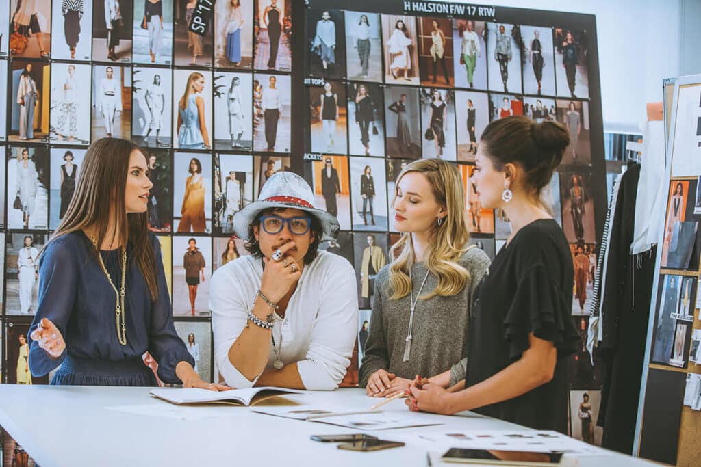 Photographer consulting with client during pre-shoot identity work and planning session