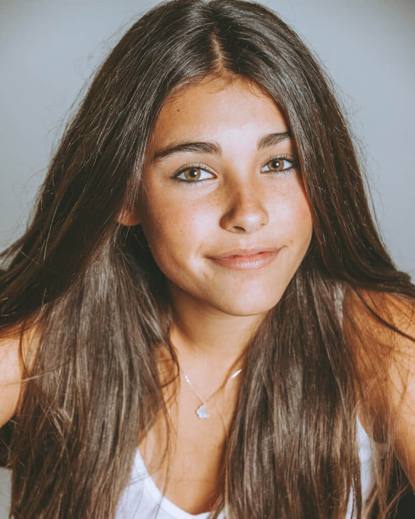 Traditional professional headshot with neutral background and clean lighting