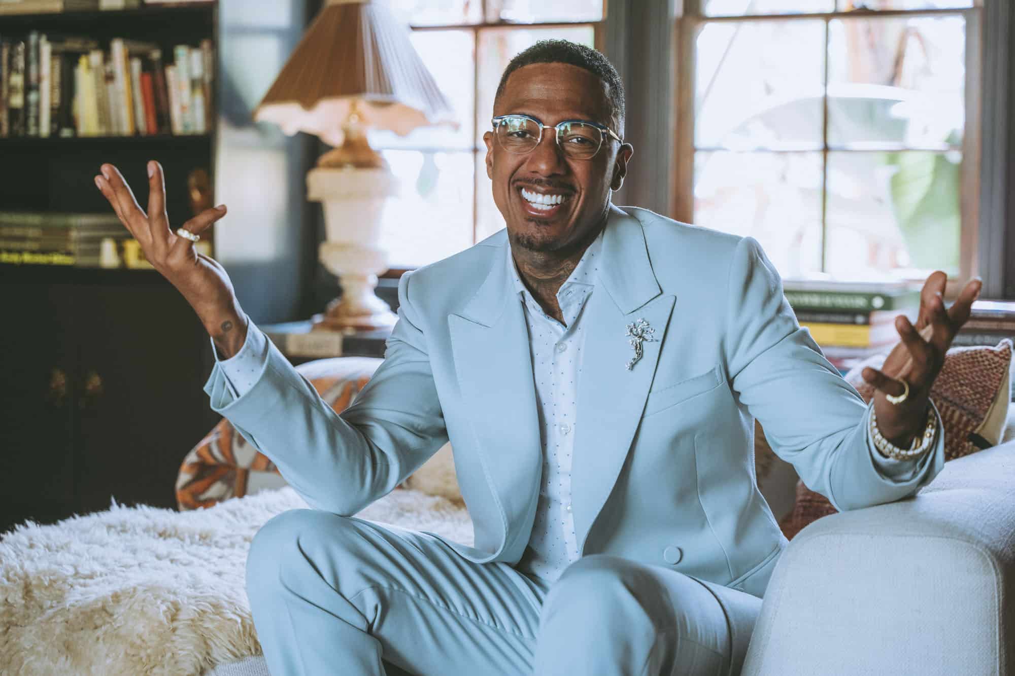Elevated Realism portrait of Nick Cannon at ease in a light blue suit, brand photography that matches who the subject has become